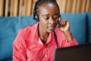 african woman call center agent working listening to customer in call