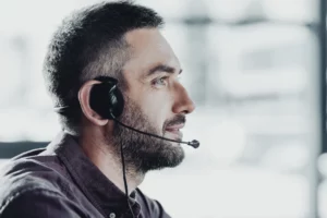 side-view-of-handsome-call-center-worker-in-headphones